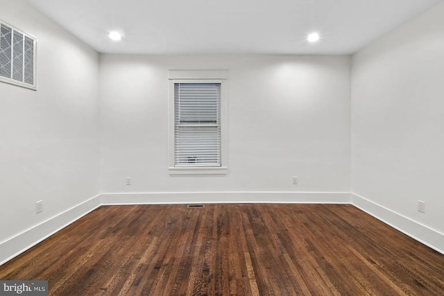 unfurnished room with dark hardwood / wood-style floors