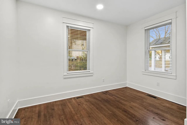 empty room with hardwood / wood-style flooring