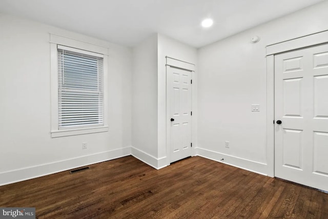 spare room with dark hardwood / wood-style floors