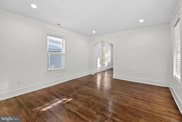 unfurnished room with dark hardwood / wood-style floors