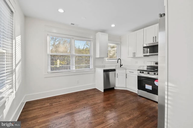 kitchen featuring white cabinetry, sink, dark hardwood / wood-style flooring, and stainless steel appliances