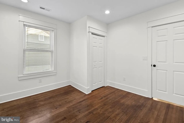 unfurnished room featuring dark wood-type flooring