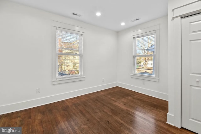 unfurnished room with hardwood / wood-style flooring