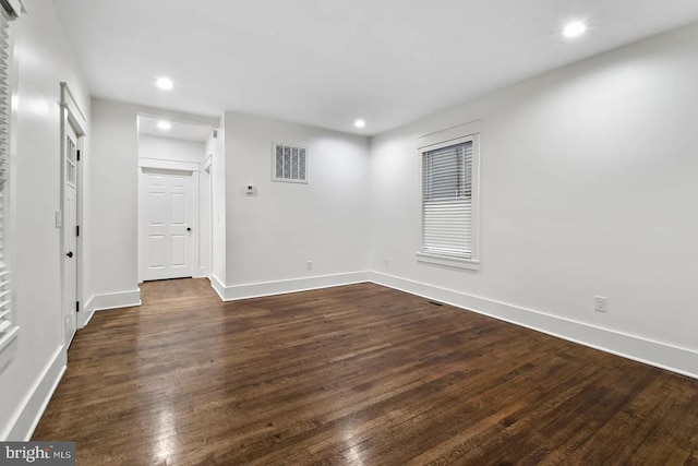 empty room with dark wood-type flooring