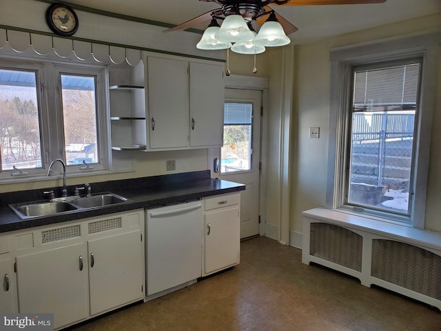 kitchen featuring radiator, white cabinetry, dishwasher, sink, and ceiling fan