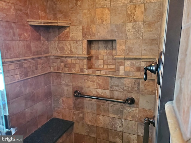 interior details featuring tiled shower