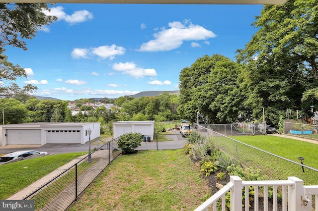 view of yard with a garage and a mountain view