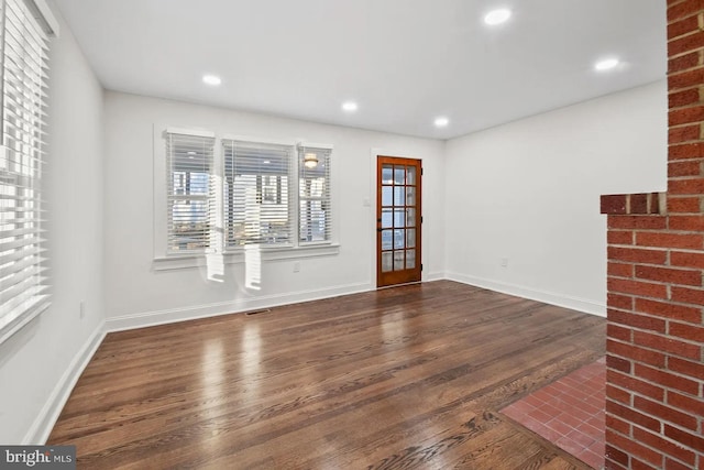 spare room featuring dark hardwood / wood-style flooring