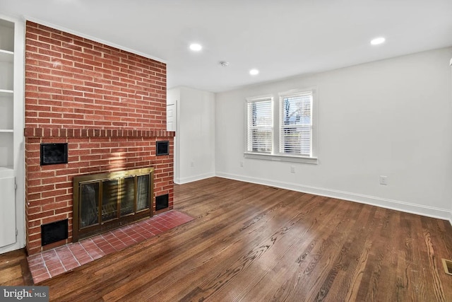 unfurnished living room featuring hardwood / wood-style floors and a fireplace