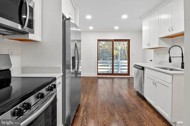 kitchen with white cabinetry, sink, stainless steel appliances, and dark hardwood / wood-style floors