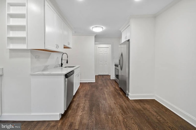 kitchen featuring sink, dark wood-type flooring, appliances with stainless steel finishes, white cabinetry, and light stone countertops