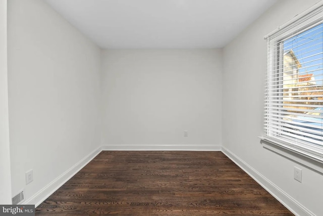 empty room featuring dark hardwood / wood-style flooring