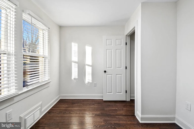 spare room with dark wood-type flooring