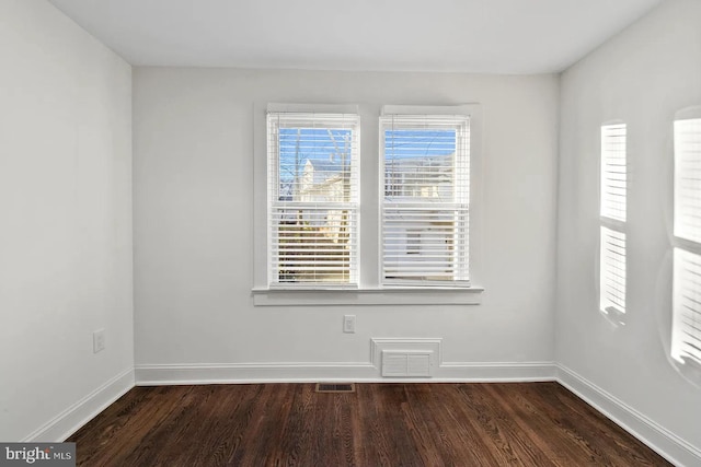 unfurnished room featuring dark hardwood / wood-style floors