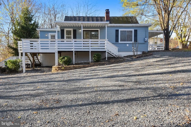 back of house featuring a wooden deck