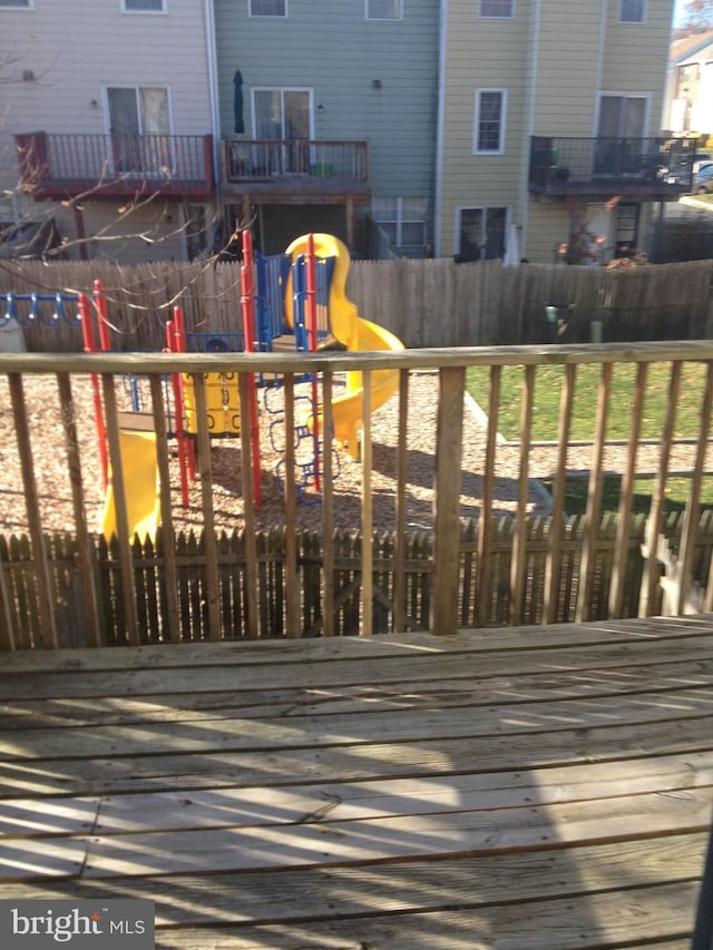 wooden terrace with a playground