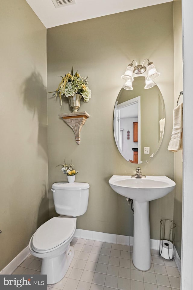 bathroom featuring tile patterned flooring, toilet, and baseboards