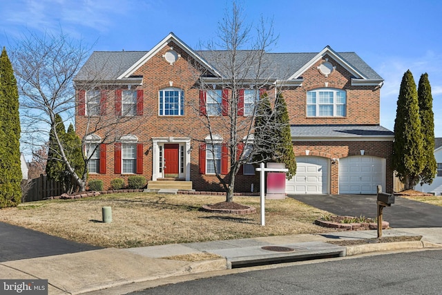 view of front of home featuring brick siding, a shingled roof, fence, aphalt driveway, and a garage