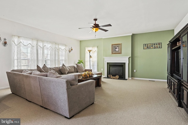 living area featuring a ceiling fan, a fireplace with flush hearth, light colored carpet, and baseboards