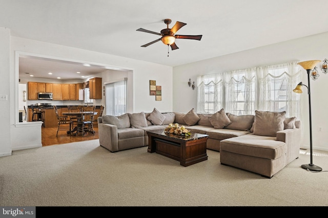 living area featuring recessed lighting, ceiling fan, baseboards, and carpet