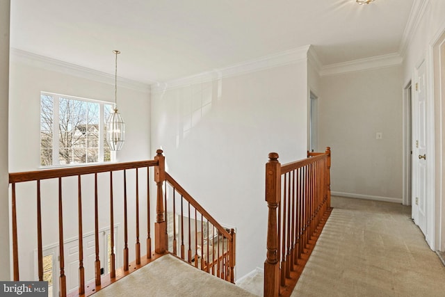 stairs featuring ornamental molding, carpet, baseboards, and a chandelier