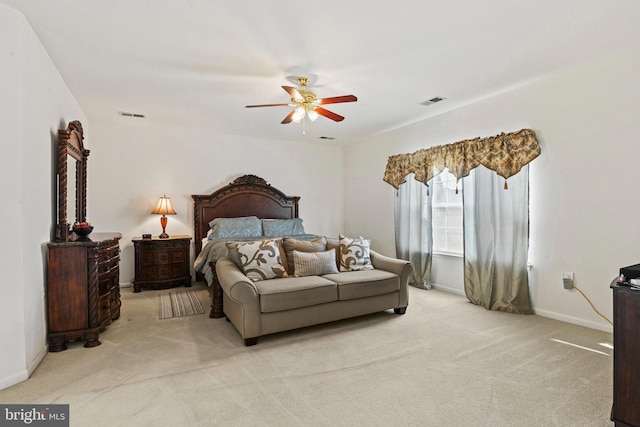 bedroom featuring light carpet, visible vents, baseboards, and a ceiling fan