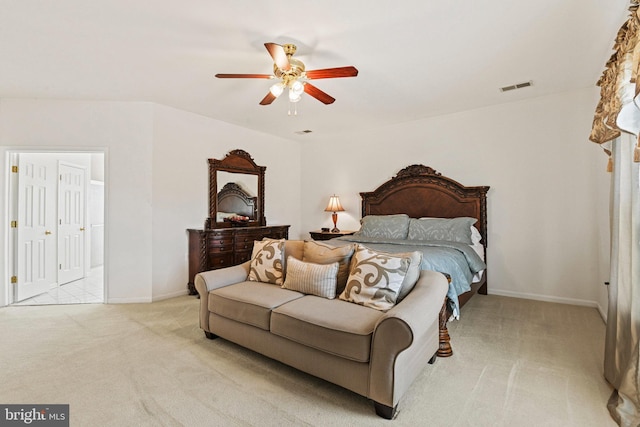 bedroom featuring visible vents, light carpet, baseboards, and ceiling fan