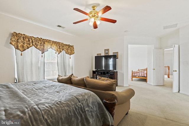 bedroom featuring visible vents, baseboards, light colored carpet, and ceiling fan