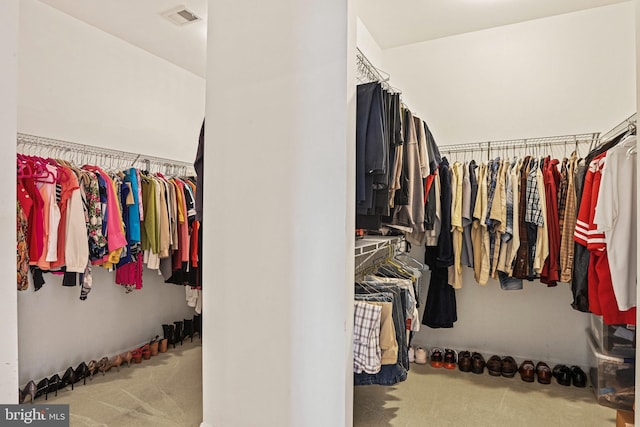 walk in closet with visible vents and carpet