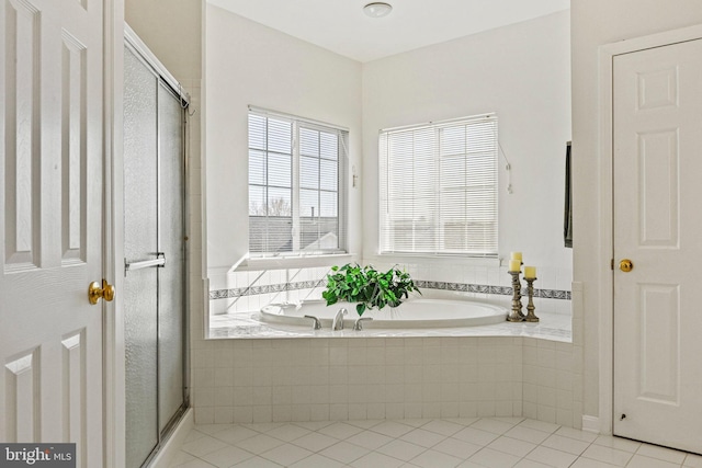 bathroom with a bath, tile patterned flooring, and a stall shower