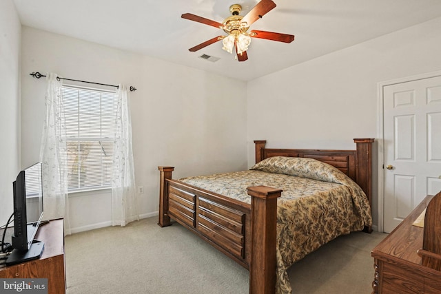 bedroom featuring a ceiling fan, light colored carpet, visible vents, and baseboards