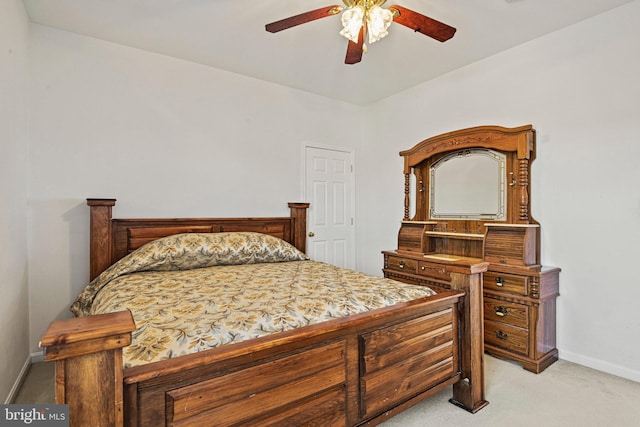 bedroom featuring light colored carpet, baseboards, and ceiling fan