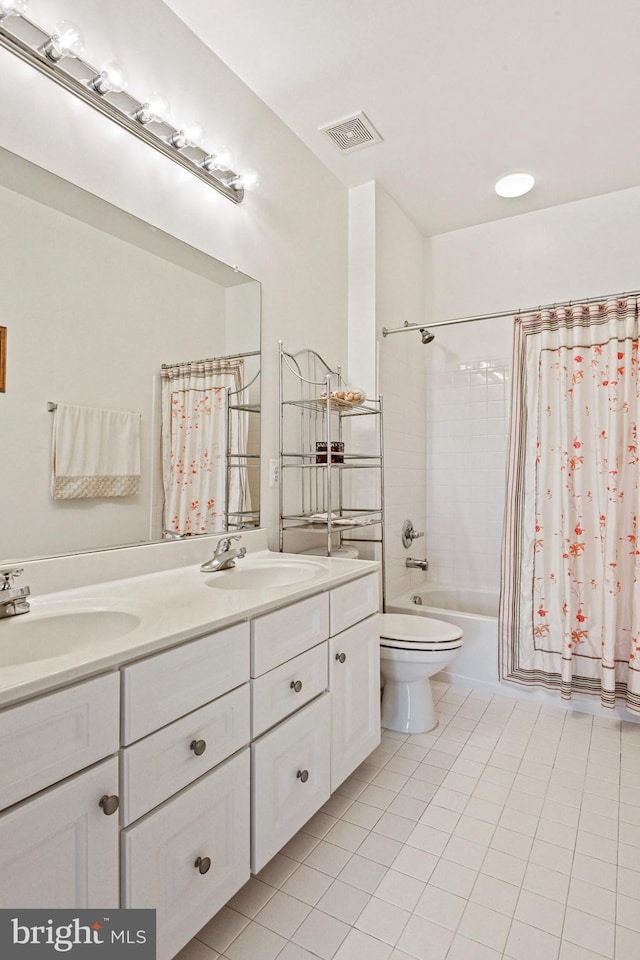 full bath with double vanity, toilet, visible vents, and a sink