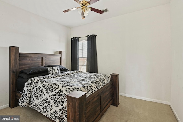 carpeted bedroom featuring visible vents, baseboards, and a ceiling fan