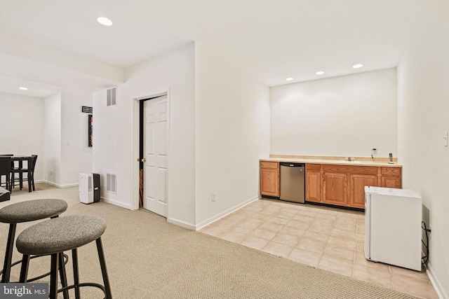 kitchen with light carpet, visible vents, recessed lighting, and brown cabinets