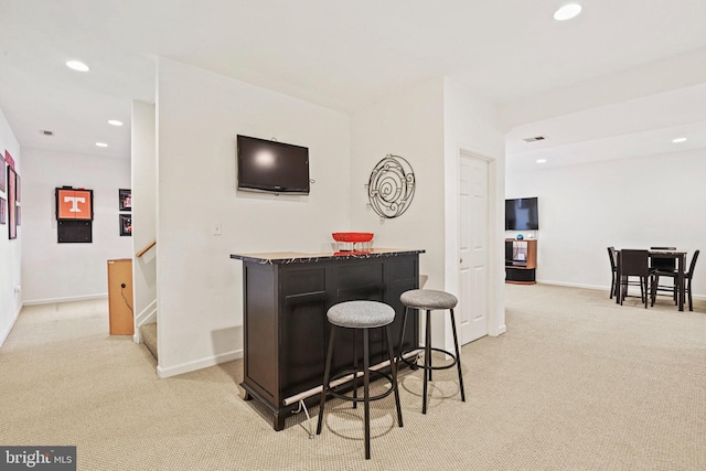 bar featuring recessed lighting, stairway, a bar, baseboards, and light colored carpet