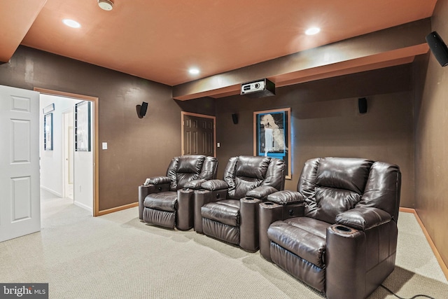 carpeted cinema room with recessed lighting and baseboards