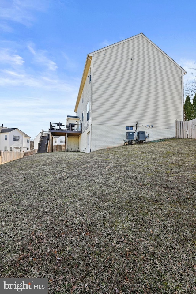 view of side of property featuring stairs and fence