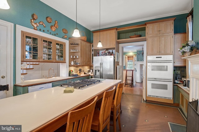 kitchen with crown molding, hanging light fixtures, appliances with stainless steel finishes, a kitchen breakfast bar, and backsplash