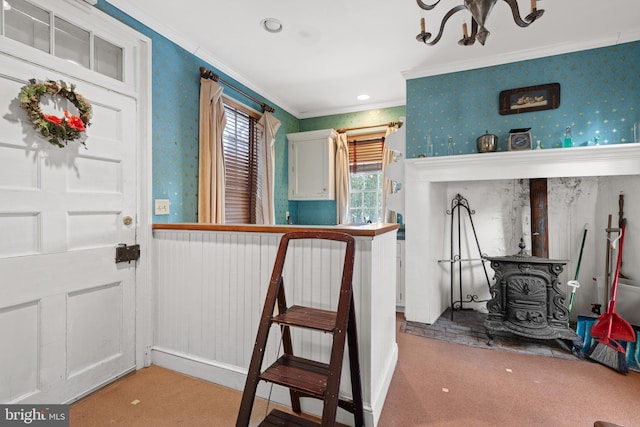 interior space with crown molding, carpet, and a wood stove