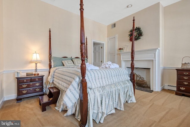 bedroom featuring a baseboard radiator and light colored carpet