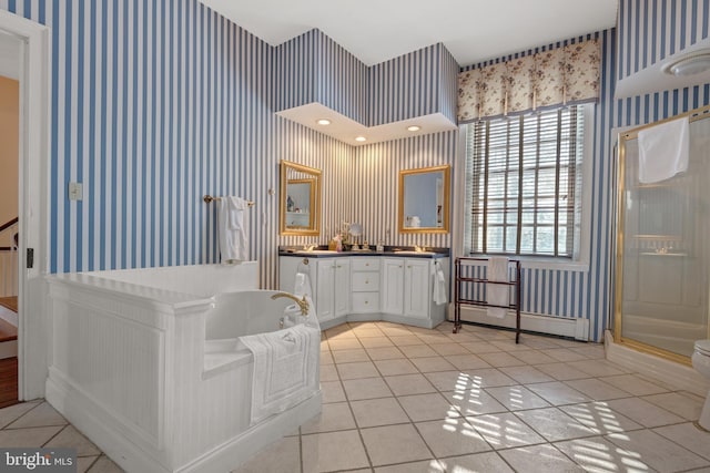 bathroom featuring vanity, independent shower and bath, tile patterned flooring, and a baseboard heating unit