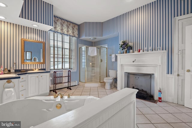 bathroom featuring toilet, vanity, a shower with door, tile patterned flooring, and a baseboard heating unit