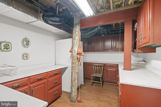 kitchen with hardwood / wood-style floors and white fridge