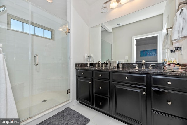 bathroom with tile patterned flooring, vanity, and a shower with shower door