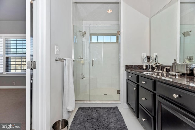 bathroom with vanity, tile patterned floors, and a shower with shower door