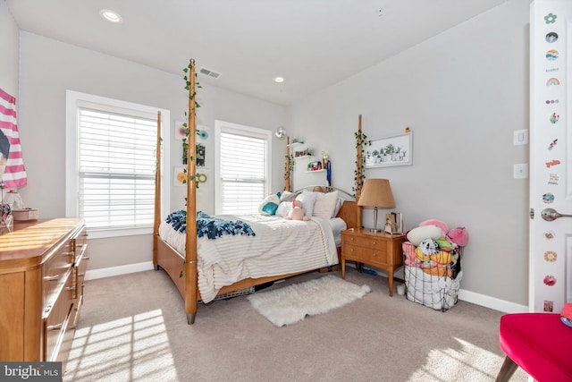 carpeted bedroom featuring multiple windows