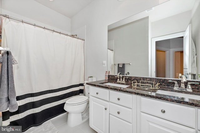 bathroom with vanity, tile patterned floors, and toilet