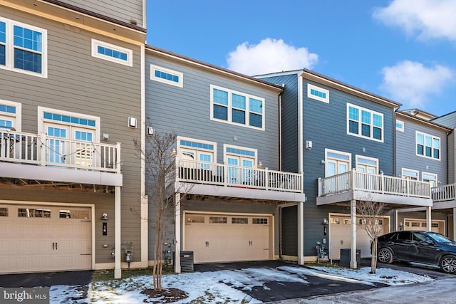 snow covered rear of property with central AC