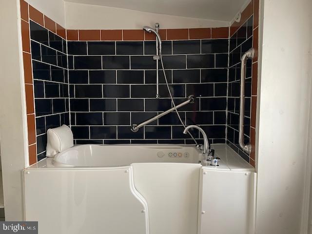 bathroom featuring lofted ceiling